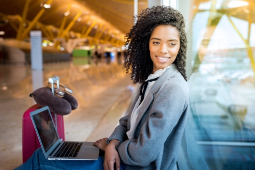 Traveller with a laptop at the airport, ready to work on the move